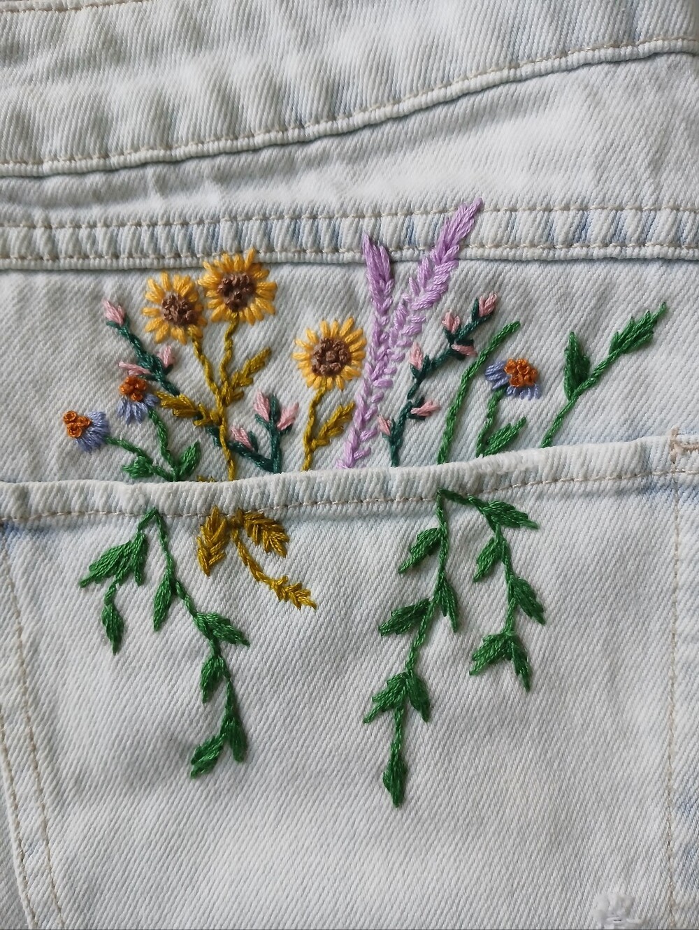 Women's acid wash denim cutoff shorts with hand stitched embroidery